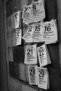 Pieces of paper indicating dates in a month pinned to a wall